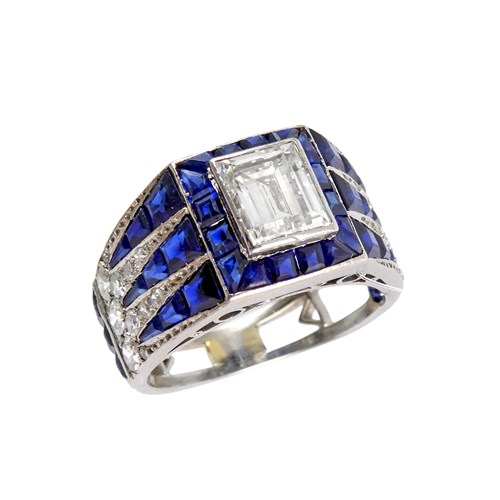 Art Deco diamond and sapphire cluster ring, French c.1925, central rectangular cut diamond of approximately 1.00ct, between calibre sapphire and diamond dart shoulders,